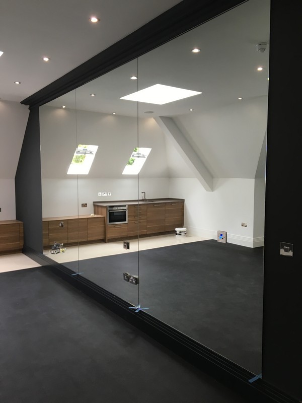 Frameless glass partition in loft conversion by Banbury glaziers